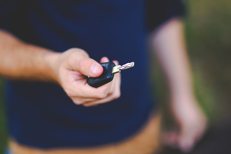 a man holding his car key