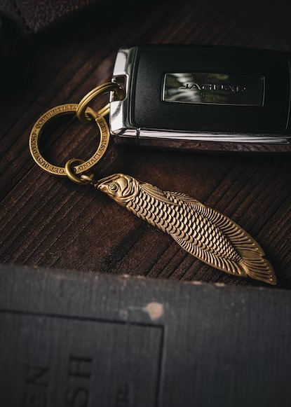 a jaguar key with a golden fish keychain