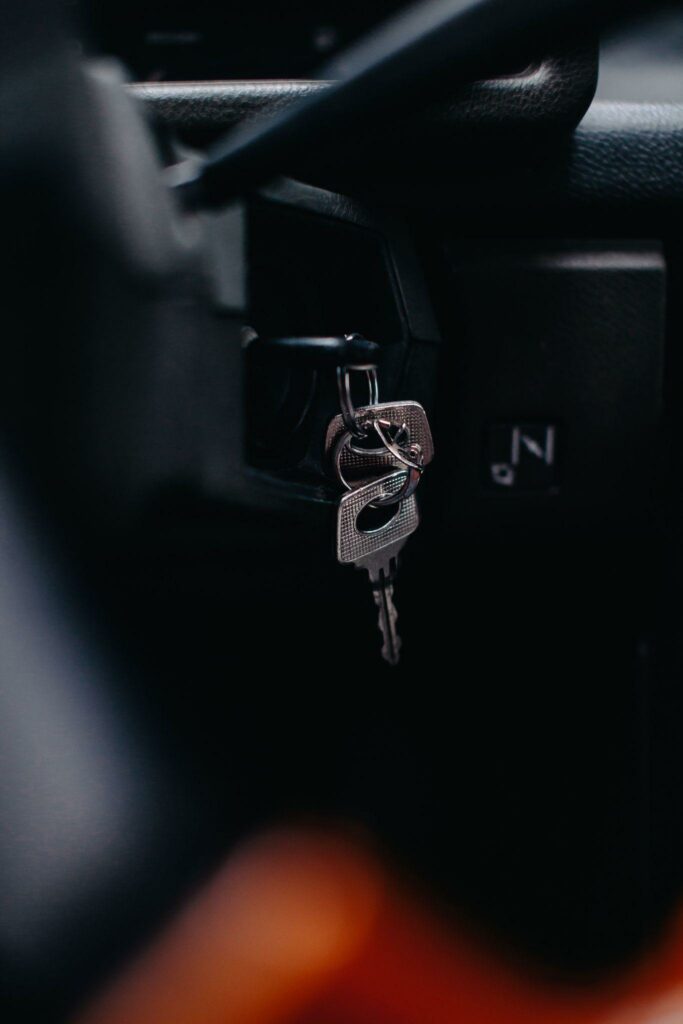 silver car keys dangling from the car key ignition 