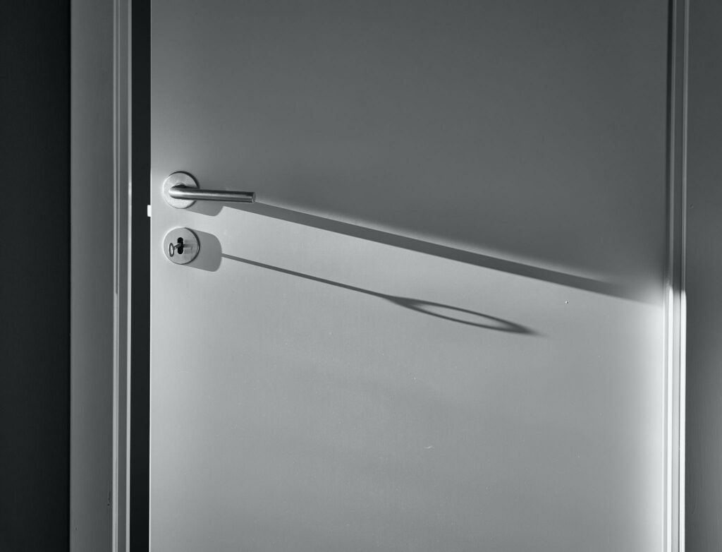 a silver door with silver door knob and lock